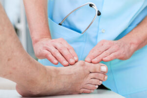 Orthopedist at work checking patient's foot